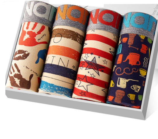 A collection of four vibrant boxer briefs in a gift box featuring unique designs: handprints, abstract shapes, stars and stripes, and coffee-themed patterns. Each brief ensures a comfortable fit while showcasing part of the brand name along the waistband.