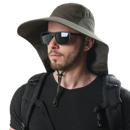 A bearded man is wearing a dark wide-brimmed CJ'S Men’s And Women’s Outdoor Sun Protection Ventilation Cap with a chin strap, sunglasses, and a black T-shirt. He has a black backpack on his shoulders, and the background is white and plain.