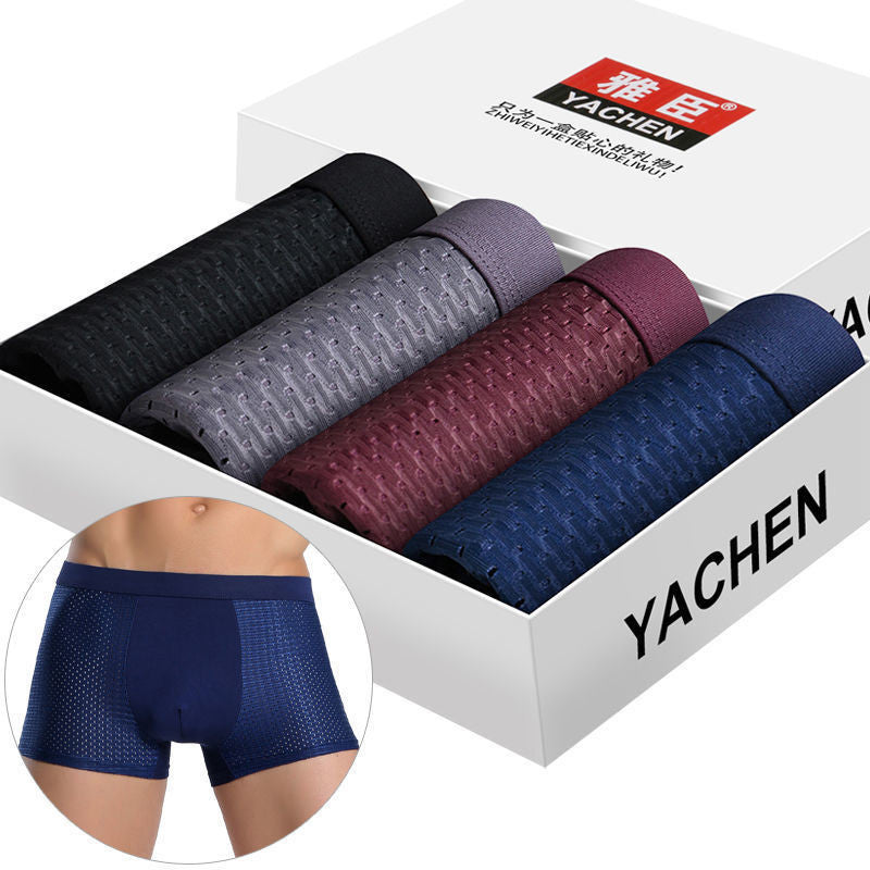 A box of "Men's Breathable Mesh Boxer Briefs Set - Cool and Comfortable Fit" includes black, gray, burgundy, and blue briefs. Each pair is neatly rolled to enhance style and comfort. The packaging proudly displays the brand name "Yachen" along with a photo of a person wearing the blue briefs.