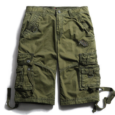 The Men's Tactical Cargo Shorts - Durable Outdoor Adventure Wear are displayed flat against a white background, featuring an olive green color, multiple pockets, belt loops, and drawstrings on the sides, making them ideal for outdoor adventures.