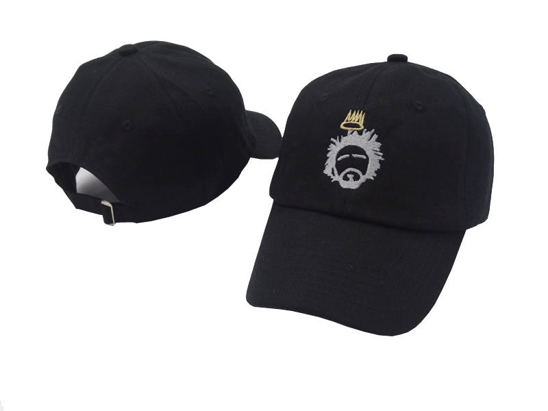 Two black caps from CJ'S streetwear collection are on display. The front cap, the Crown and Beard Embroidered Cotton Baseball Cap, showcases its distinctive logo design. Meanwhile, the back cap highlights its adjustable strap feature. Both caps are strategically placed to offer a complete perspective.