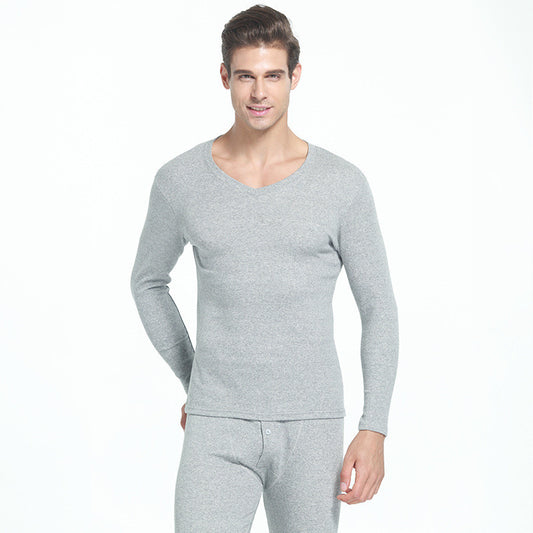 Someone is wearing the Men's Warm Thermal Underwear Set, which is soft, breathable, and comfortable. The set includes a light gray long-sleeve top and matching bottoms that stand out against the plain white background. This lightweight and stretchy thermal set offers exceptional comfort with its heat-retaining fabric.