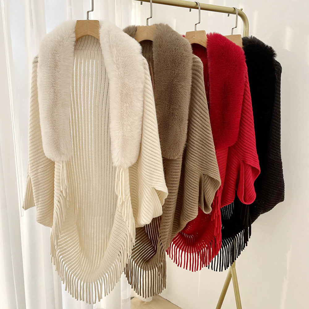 Four CJ'S Scarf Women Solid Color Cashmere shawls are hanging on a rack, each crafted from knitted cashmere material and featuring a fur collar with fringe along the bottom edge. These solid color shawls come in cream, taupe, red, and black, arranged from left to right against a backdrop of white curtains.