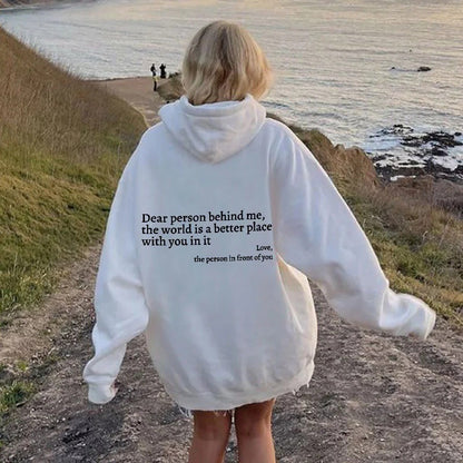 Woman wearing white hoodie on the beach