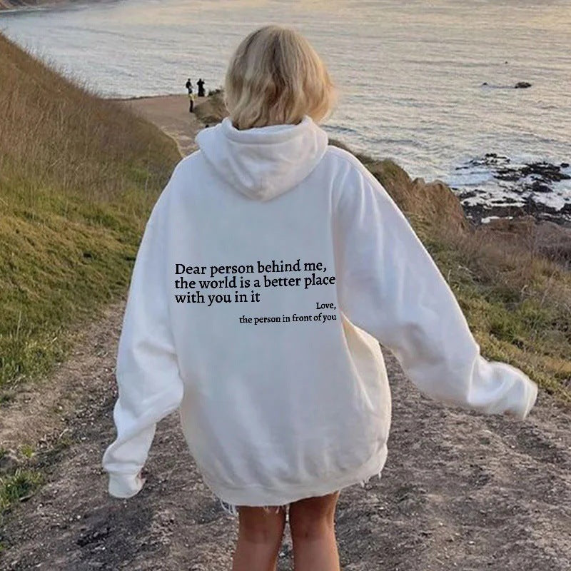 Model wearing white unisex hoodie outdoors