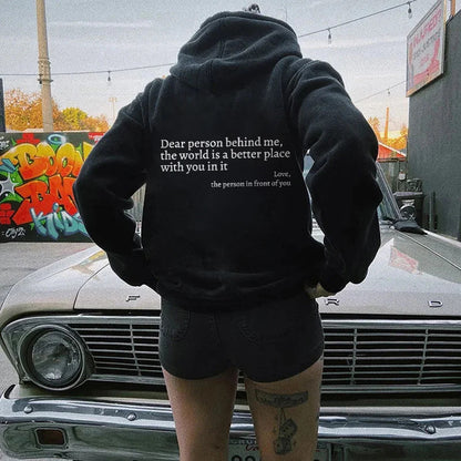 Model wearing black unisex hoodie outdoors