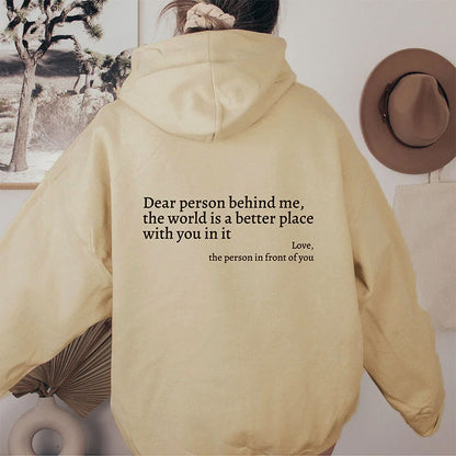 Close-up of inspirational quote on beige hoodie back