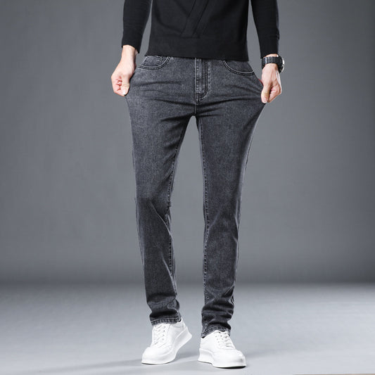 A person wearing a black long-sleeve shirt, Zendrop Versatile Stretch Slim Straight Men's Jeans in gray, and white sneakers stands against a gray background. The person's hands are in their jeans pockets, and their head is not visible in the image.