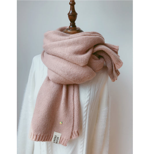 A plush, light pink Zendrop Shawl Accessories Cashmere Scarf Women Scarfs Winter, measuring 195*40cm and made of imitation cashmere, is elegantly draped around a white sweater on a dress form. The scarf features a soft, woolen texture and a small white tag near the bottom with the brand logo and text. The simple and uncluttered background highlights the garment beautifully.