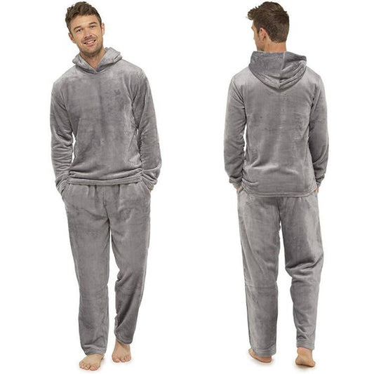 A man models the Men's Cosy Plush Hooded Loungewear Set in a plush gray, crafted from ultra-soft fabric. The set features a long-sleeved top and matching pants, shown from both front and back views, with hands tucked into pockets. He is barefoot against a white backdrop.