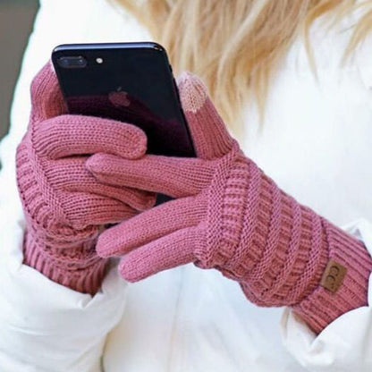 A person is using a smartphone while wearing European and American wool knitted touch screen gloves. The gloves perfectly complement the white jacket, making it a cozy and stylish choice for winter outings.