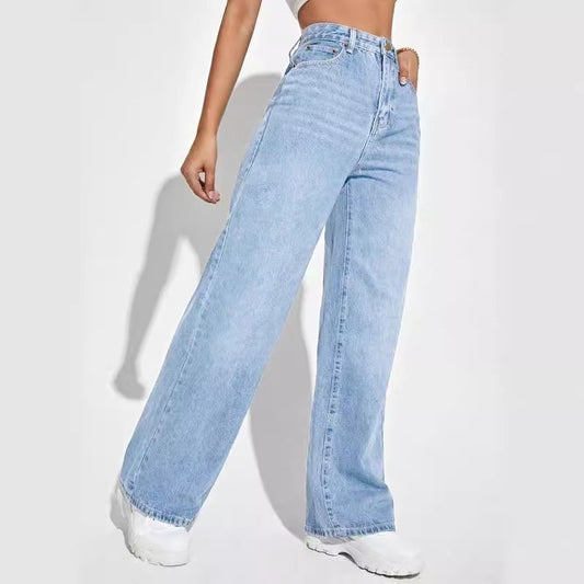 A person wearing Zendrop's European And American Ladies Jeans High Waist Slim Straight in light blue and white sneakers stands against a plain white background. Only the lower torso and legs are visible, with one hand resting by their side.