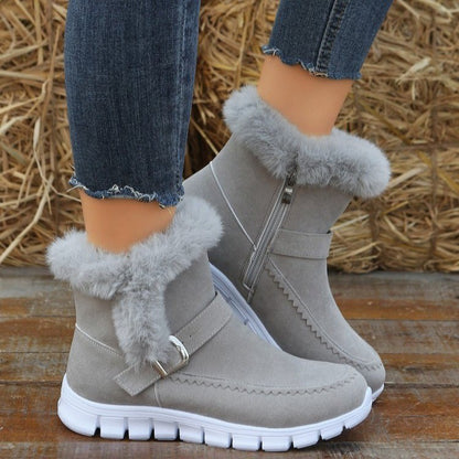 Side zipper detail on women's plush ankle winter boots for easy on and off functionality.